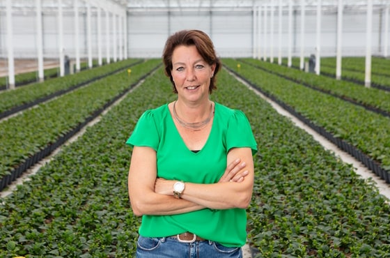 Sandra van den Bosch in greenhouse in front of plants