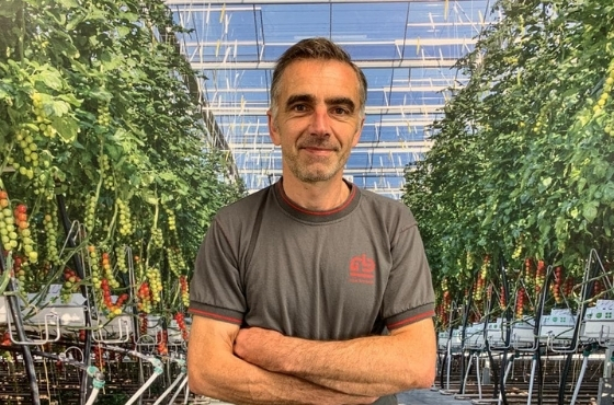 Arnaud Brezellec in greenhouse in between plants