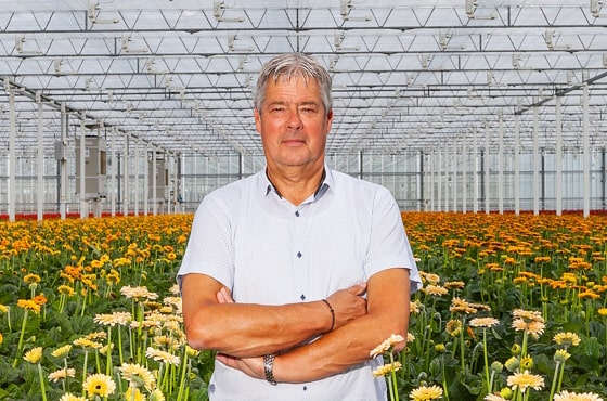 Eef Zwinkels in greenhouse with flowers