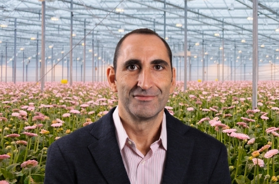 Jesus Yllera in greenhouse with flowers