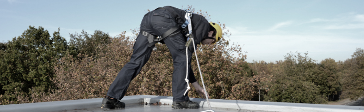 Men working on roof with safety harness